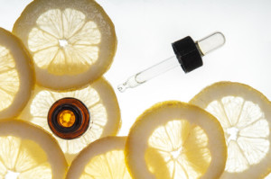 Essential oil amber glass bottle with slices of lemon